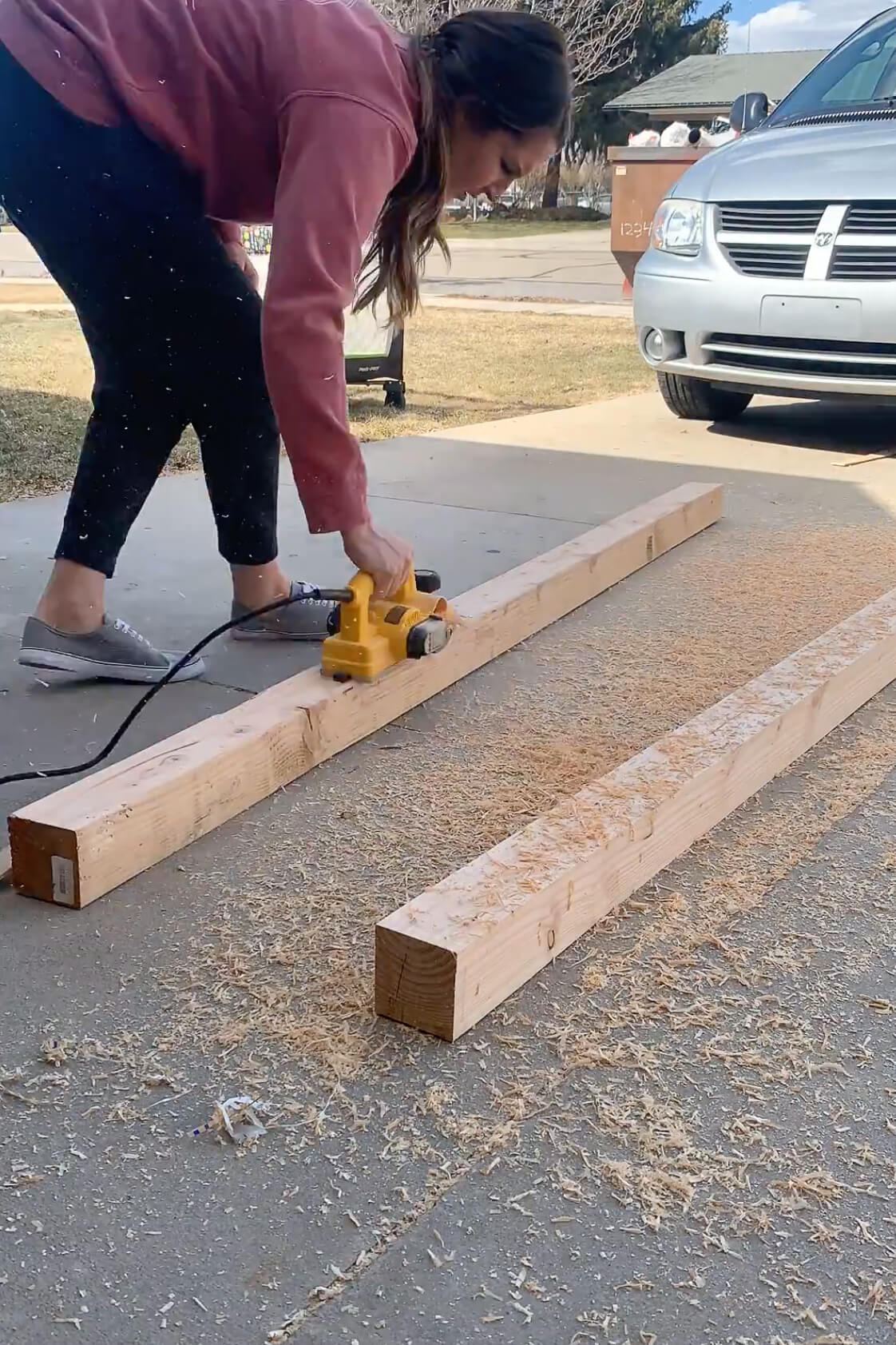 Planing wood for table legs on a DIY table.